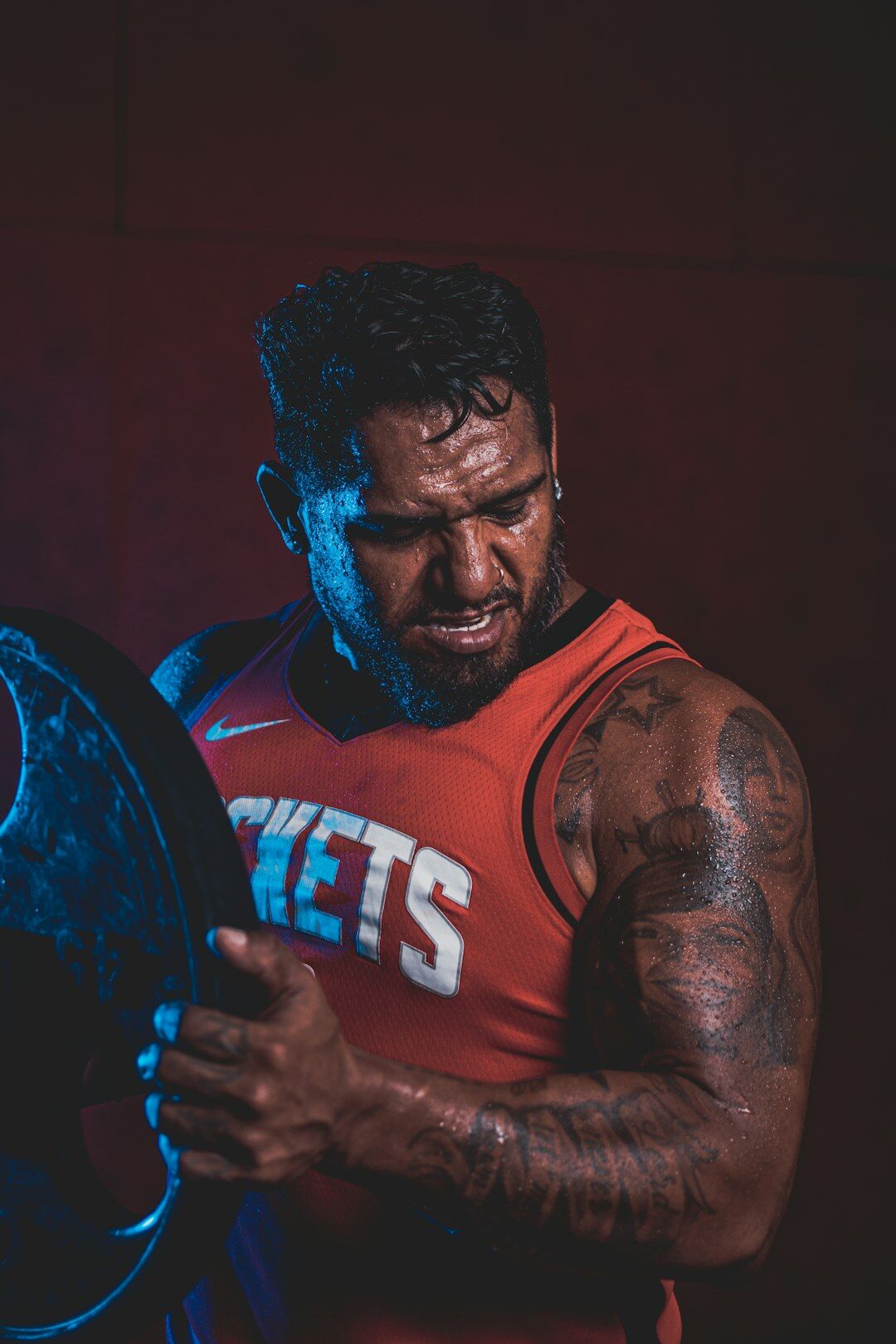 Indian Singaporean male strength coach smiling in athletic wear